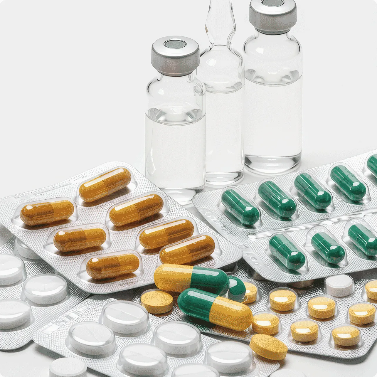 various shape and coloured tablets and clear liquid in small jars in a lab